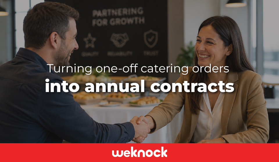 A restaurant operator and corporate client shaking hands over an agreement to turn one-off catering orders into annual contracts.